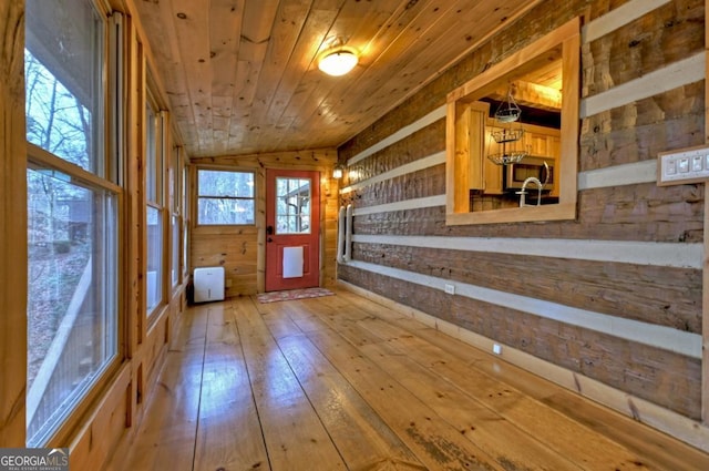 interior space featuring wood walls, hardwood / wood-style floors, and wood ceiling