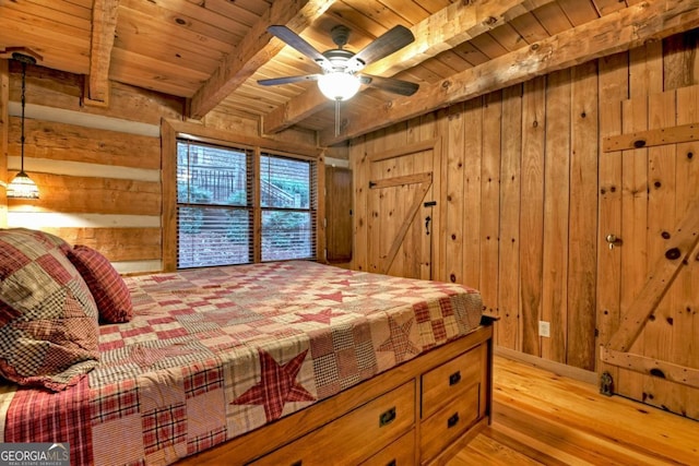 bedroom featuring wood walls, wooden ceiling, light hardwood / wood-style flooring, ceiling fan, and beamed ceiling