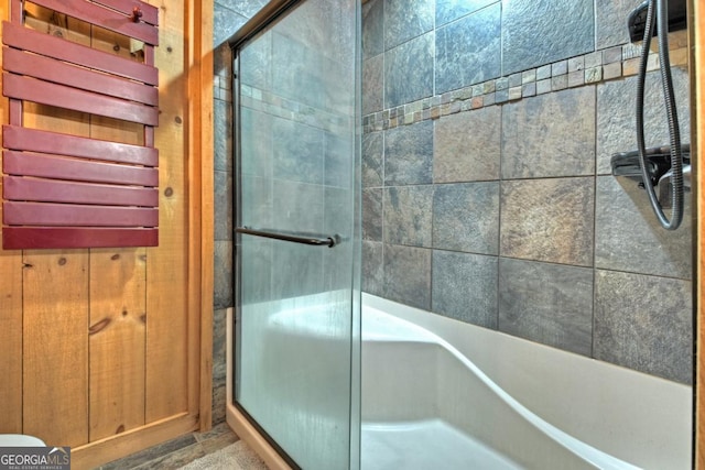 bathroom featuring a shower with shower door