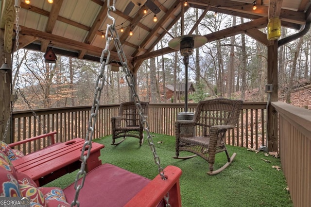 wooden terrace featuring a lawn