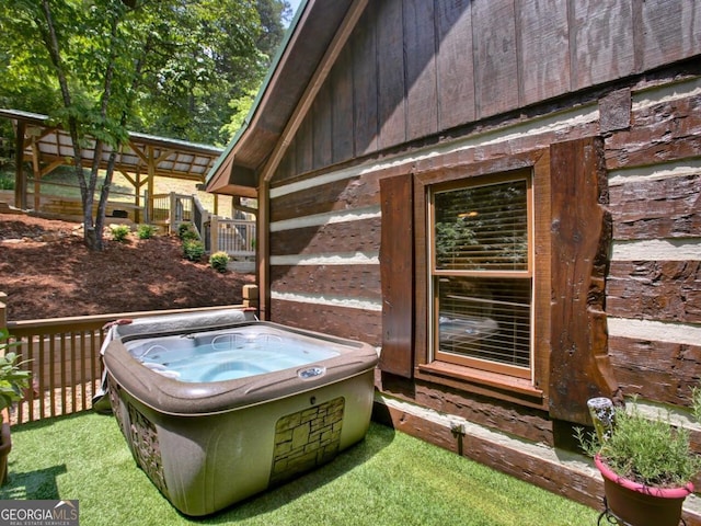 deck featuring a hot tub