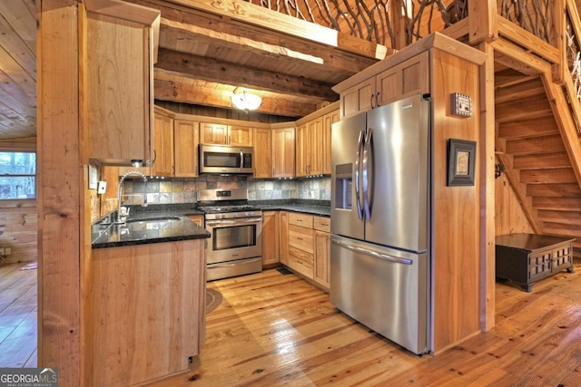 kitchen with beam ceiling, wooden ceiling, backsplash, appliances with stainless steel finishes, and light wood-type flooring