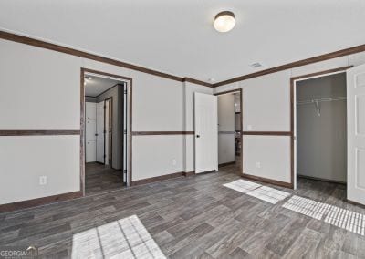 unfurnished bedroom featuring dark hardwood / wood-style flooring, a closet, and ornamental molding