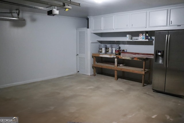 garage featuring stainless steel refrigerator with ice dispenser