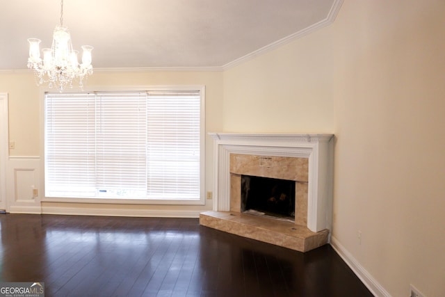 unfurnished living room with dark hardwood / wood-style flooring, an inviting chandelier, a high end fireplace, and ornamental molding