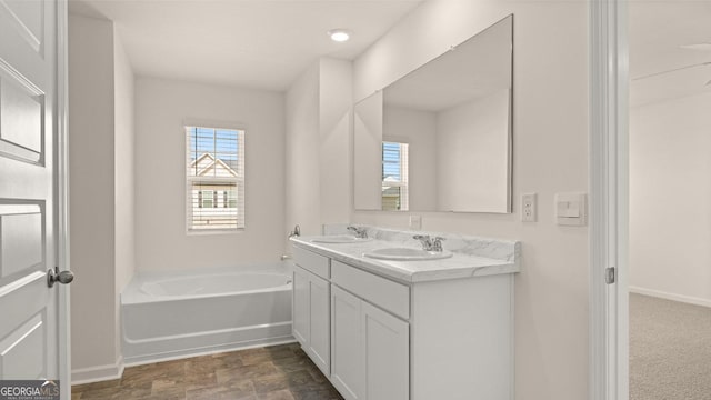 bathroom featuring vanity and a bath