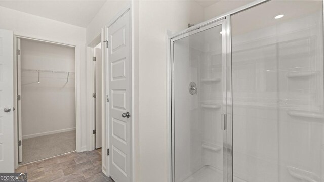 bathroom featuring a shower with shower door