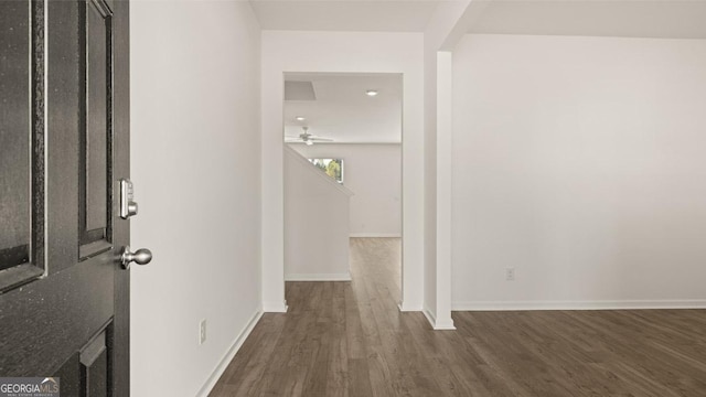 hallway with dark hardwood / wood-style flooring