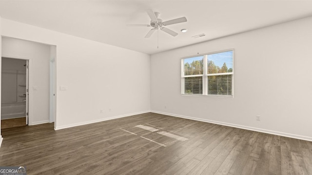 spare room featuring ceiling fan and dark hardwood / wood-style flooring