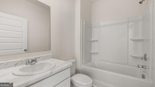 full bathroom featuring vanity, bathtub / shower combination, and toilet