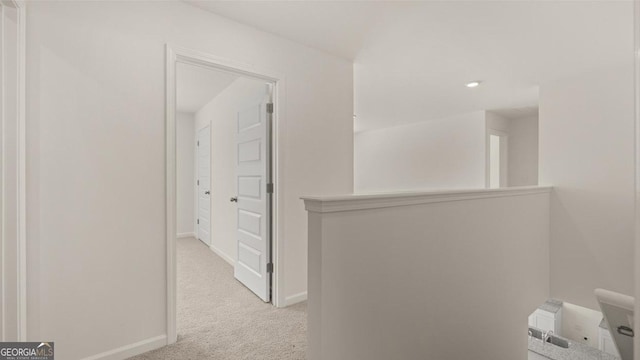 corridor with light colored carpet