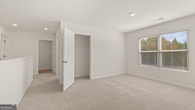 unfurnished bedroom featuring light colored carpet