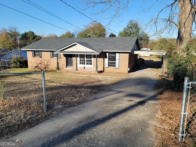 single story home featuring covered porch and a carport