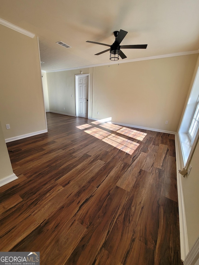 spare room featuring dark hardwood / wood-style flooring, ceiling fan, and ornamental molding