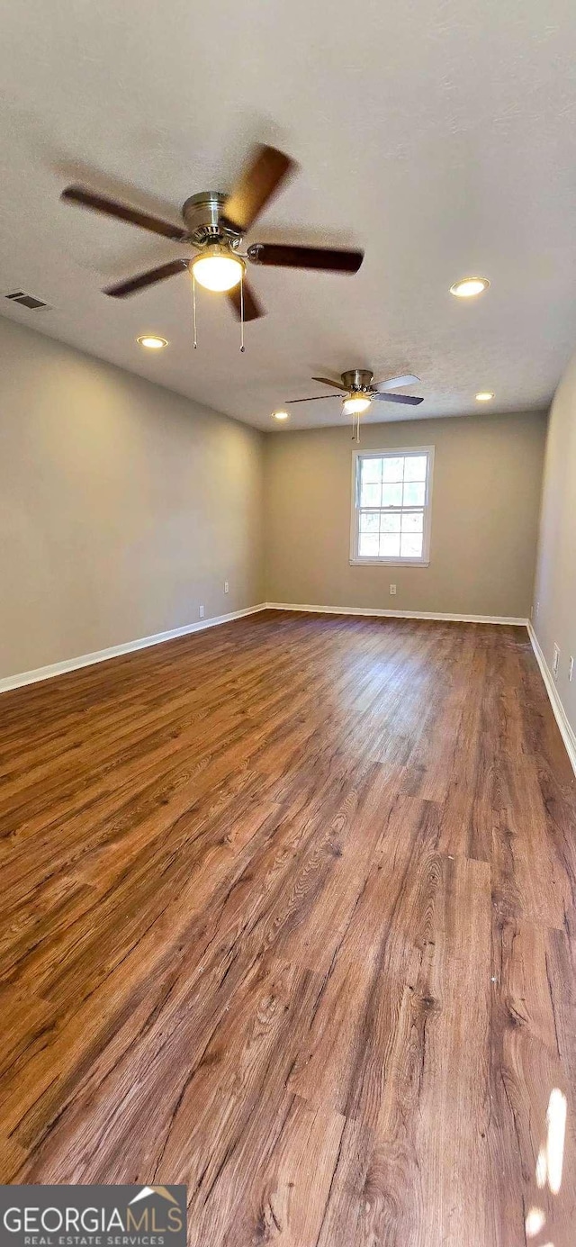 spare room with hardwood / wood-style floors