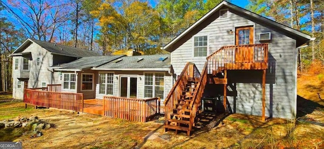 rear view of house featuring a wooden deck