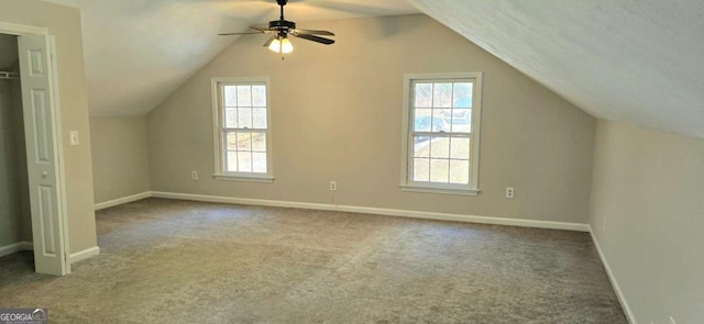 bonus room featuring ceiling fan, a healthy amount of sunlight, light colored carpet, and vaulted ceiling