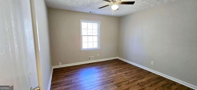 spare room with a textured ceiling, dark hardwood / wood-style floors, and ceiling fan