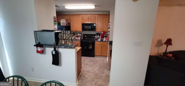 kitchen with kitchen peninsula and black appliances