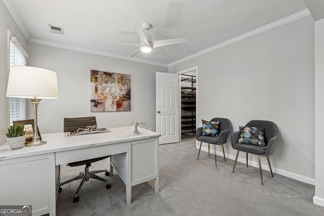 carpeted home office featuring ceiling fan and crown molding