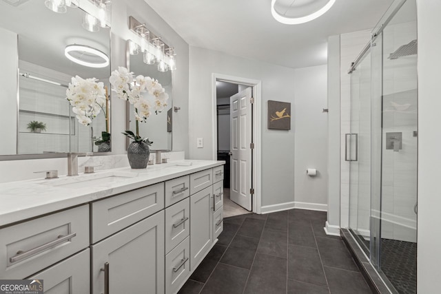 bathroom featuring tile patterned flooring, vanity, and an enclosed shower