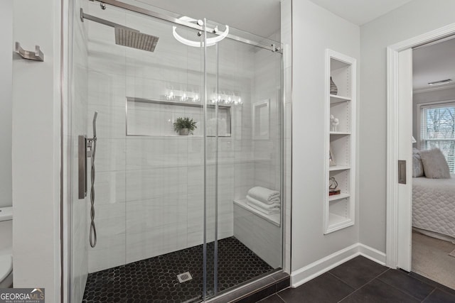 bathroom featuring tile patterned flooring and a shower with shower door