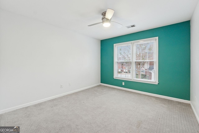 carpeted empty room with ceiling fan