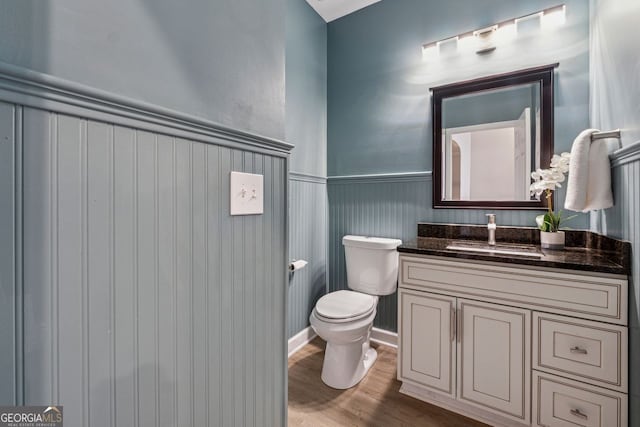 bathroom featuring hardwood / wood-style floors, vanity, and toilet