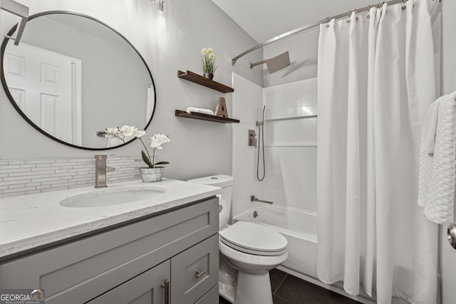 full bathroom with decorative backsplash, shower / bath combo, vanity, tile patterned flooring, and toilet