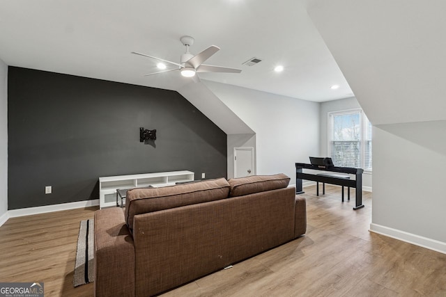 living room with light hardwood / wood-style flooring, ceiling fan, and lofted ceiling