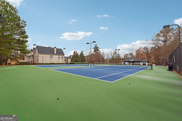 view of tennis court featuring basketball court