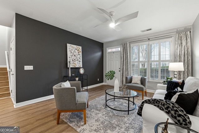 living room featuring ceiling fan and wood-type flooring