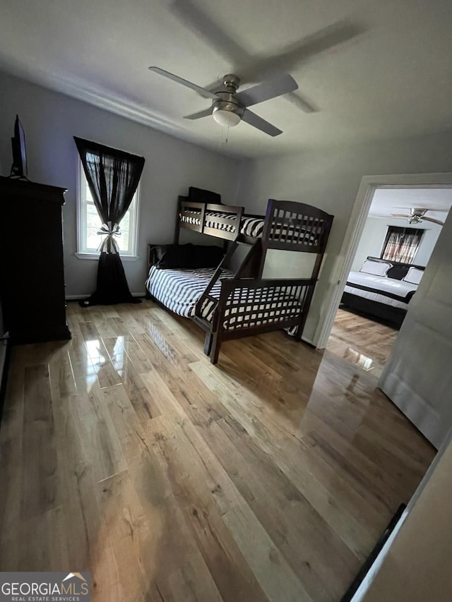 bedroom featuring light wood-type flooring and ceiling fan