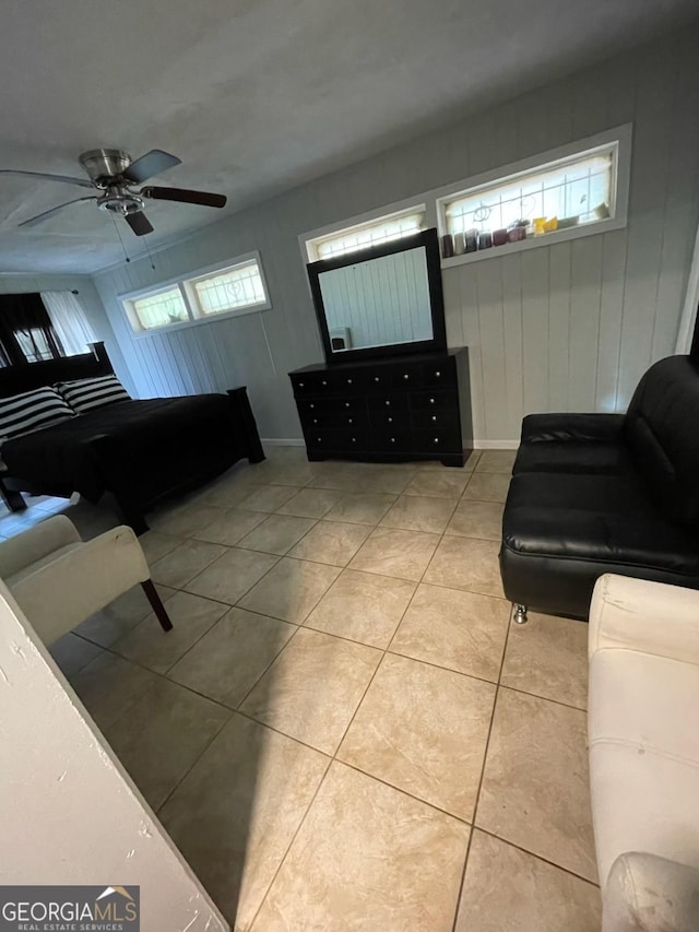 tiled living room featuring plenty of natural light and ceiling fan