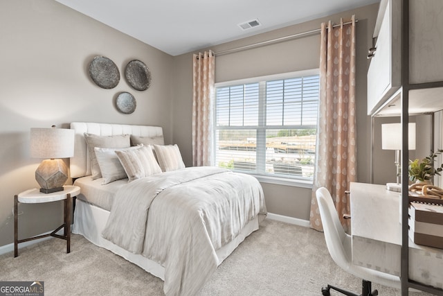 bedroom featuring light carpet, baseboards, and visible vents