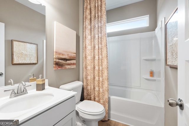 full bathroom featuring shower / tub combo with curtain, vanity, and toilet