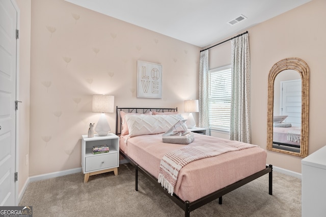 carpeted bedroom with visible vents and baseboards