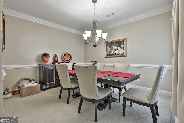 carpeted dining room featuring ornamental molding and a notable chandelier