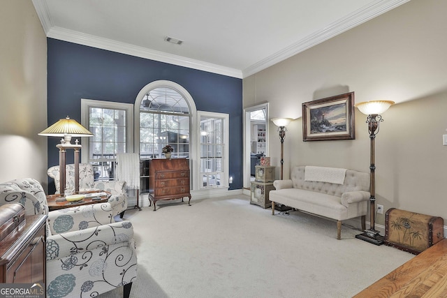 sitting room with carpet floors and ornamental molding