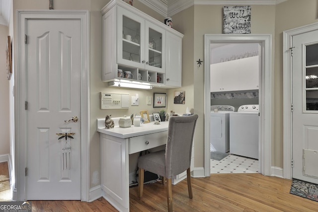 office featuring washing machine and dryer, ornamental molding, and light hardwood / wood-style flooring