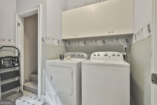 washroom featuring washer and dryer and cabinets