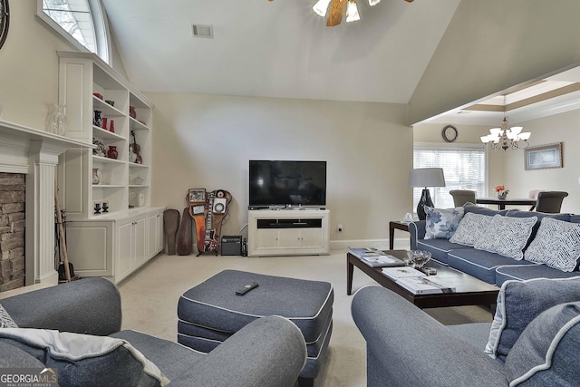 living room with ceiling fan with notable chandelier, light carpet, and high vaulted ceiling