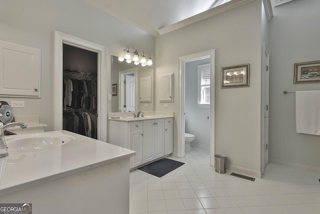 bathroom with tile patterned flooring, vanity, and toilet