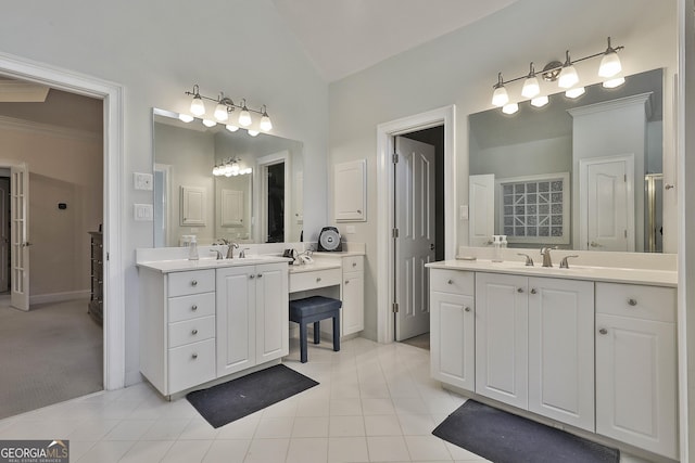 bathroom featuring tile patterned flooring, vanity, ornamental molding, and vaulted ceiling