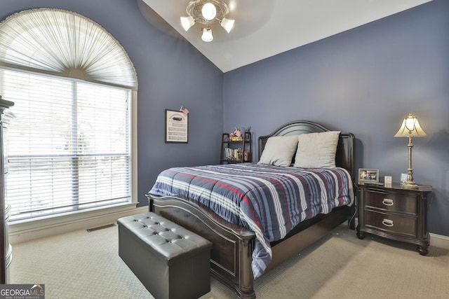 bedroom with light carpet, ceiling fan, and lofted ceiling