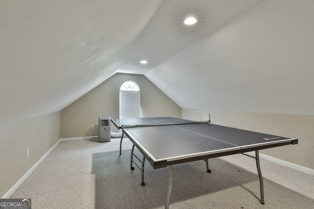 game room featuring light colored carpet and vaulted ceiling