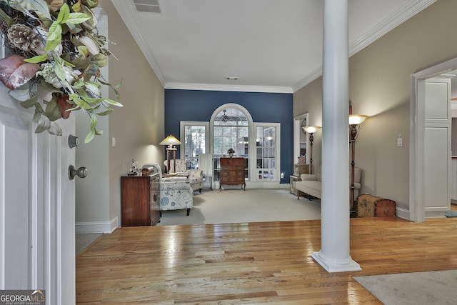 entrance foyer with ornate columns and ornamental molding