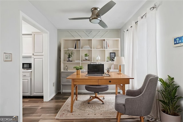 office space with ceiling fan and dark hardwood / wood-style flooring