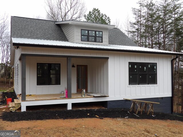 back of property with a porch