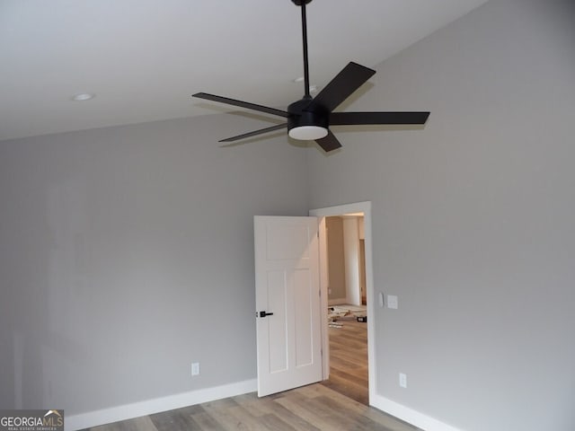 empty room with light hardwood / wood-style floors, ceiling fan, and lofted ceiling